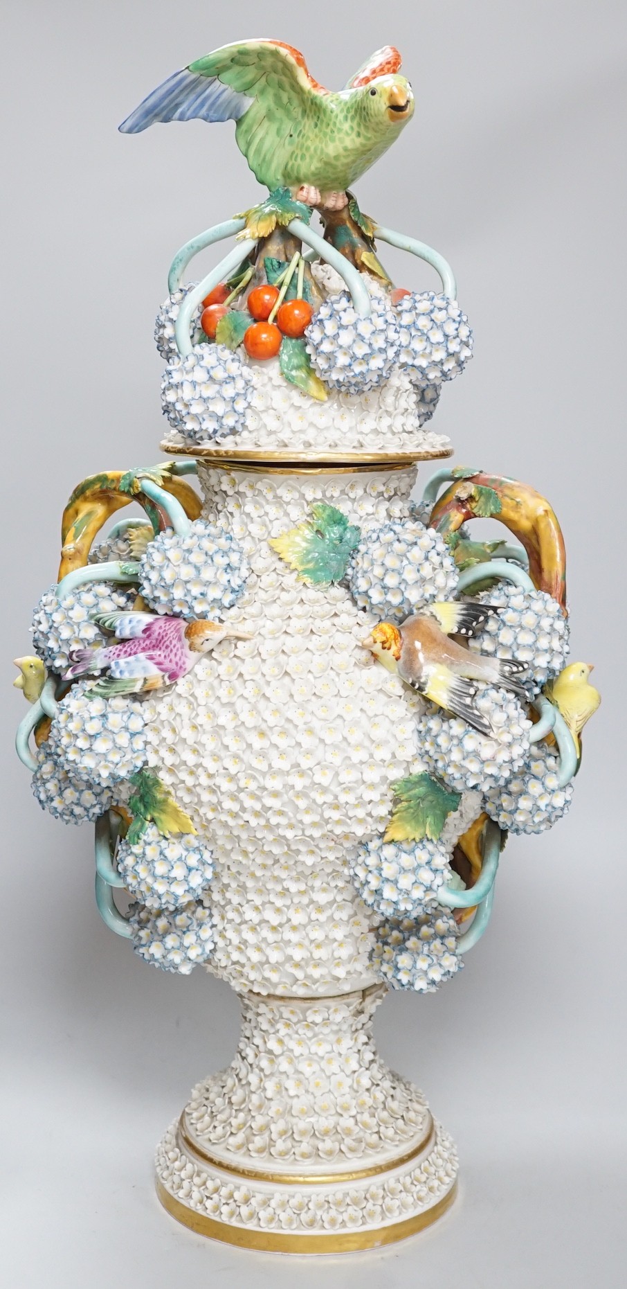 A large 19th century Jacob Petit floral encrusted two handled vase and cover, decorated with birds and flowers, 64cms high